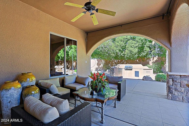 view of patio / terrace with an outdoor living space, exterior kitchen, and ceiling fan