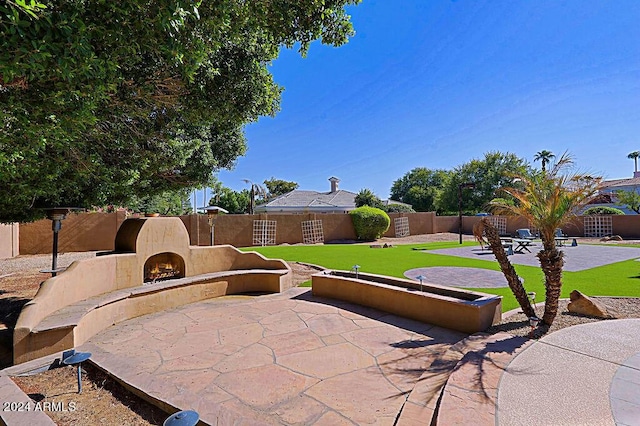 view of patio featuring exterior fireplace