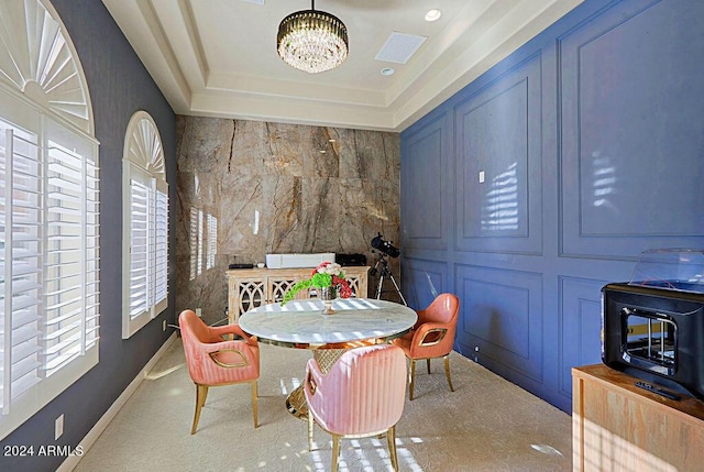 dining area featuring a chandelier and a tray ceiling