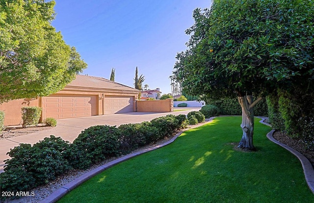 view of front of property with a garage and a front lawn