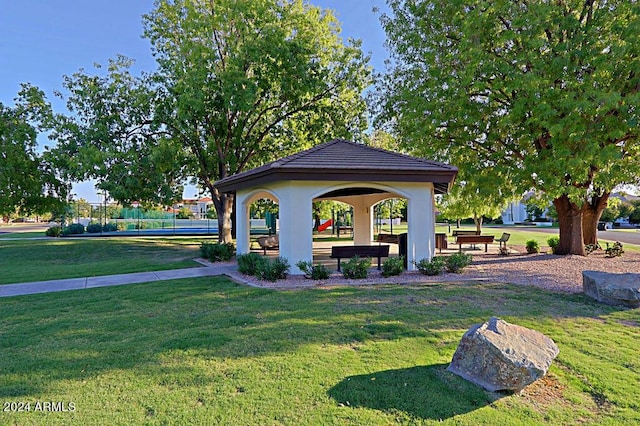 surrounding community with a lawn and a gazebo