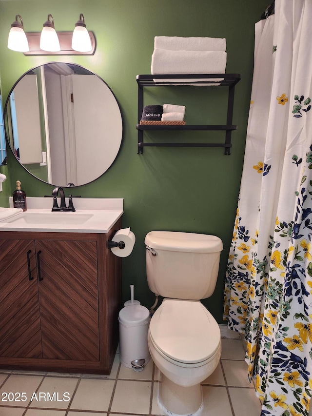 bathroom with vanity, tile patterned flooring, and toilet