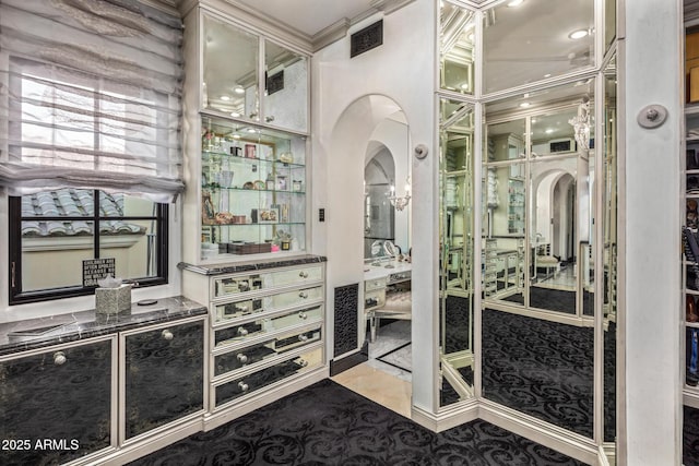 spacious closet with arched walkways