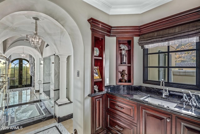 bathroom with french doors, an inviting chandelier, vanity, ornate columns, and a shower stall