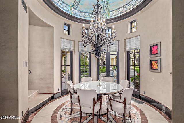 dining area featuring french doors, an inviting chandelier, a wealth of natural light, and baseboards