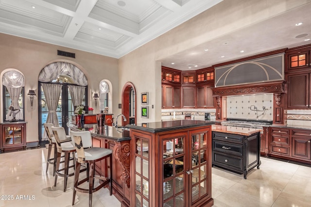 bar with french doors, custom exhaust hood, tasteful backsplash, coffered ceiling, and beamed ceiling