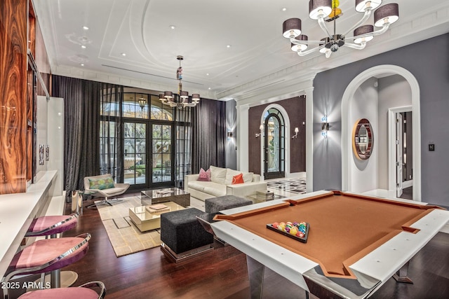 game room featuring arched walkways, pool table, dark wood-style flooring, french doors, and an inviting chandelier