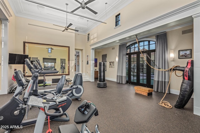 workout area with a wealth of natural light, crown molding, baseboards, and ceiling fan