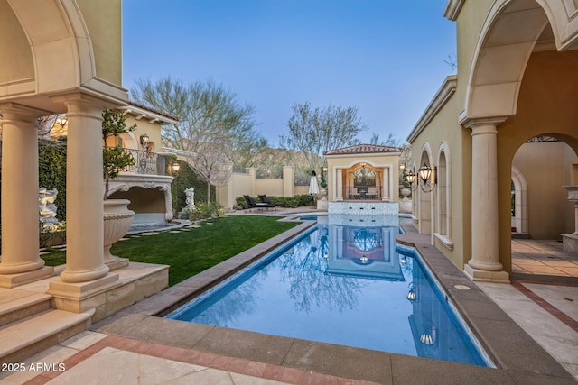 view of swimming pool with a fenced in pool, a yard, a patio, and fence