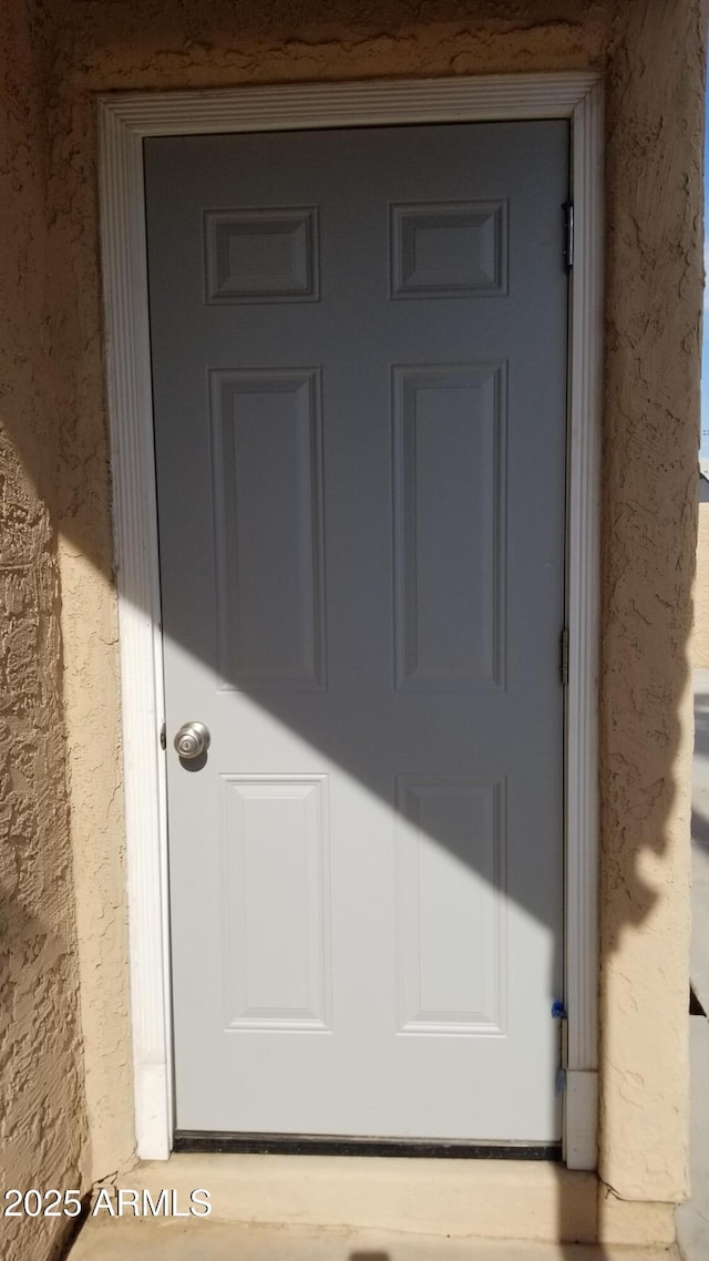 entrance to property with stucco siding