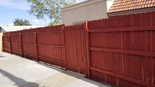 gate with fence and a patio area