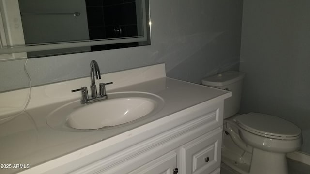 bathroom featuring toilet and vanity