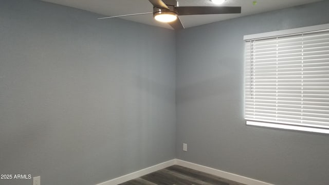 unfurnished room featuring ceiling fan, dark wood finished floors, and baseboards