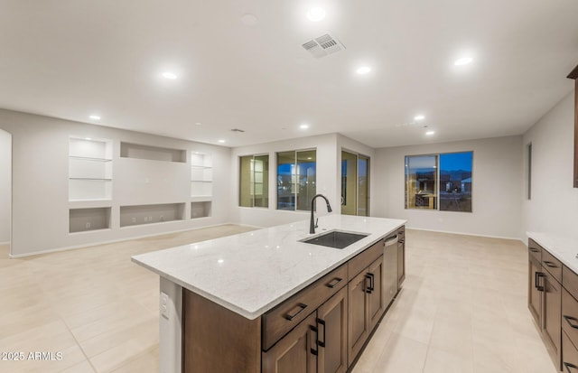 kitchen with recessed lighting, visible vents, a center island with sink, stainless steel dishwasher, and a sink
