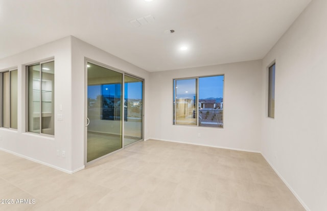 spare room with visible vents and baseboards