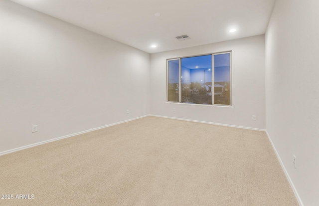 unfurnished room with carpet flooring, baseboards, visible vents, and recessed lighting