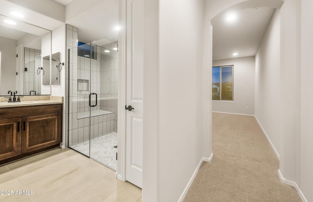 bathroom with a shower stall, recessed lighting, vanity, and baseboards