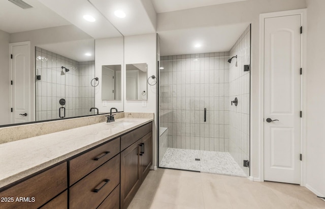 full bathroom featuring visible vents, tile patterned floors, a shower stall, and vanity