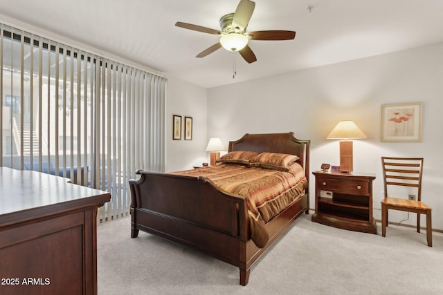 bedroom with light carpet and ceiling fan