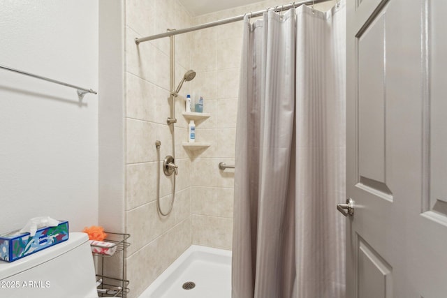 full bath featuring a stall shower and toilet