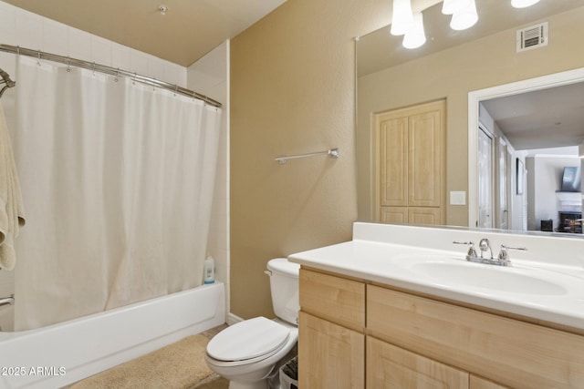 bathroom featuring vanity, toilet, and shower / tub combo