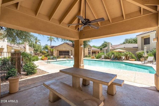 view of swimming pool featuring a patio area, a ceiling fan, and fence