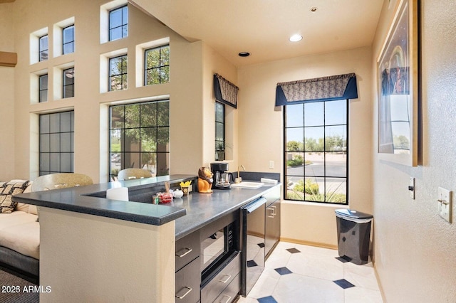 home office with plenty of natural light, a sink, recessed lighting, and baseboards