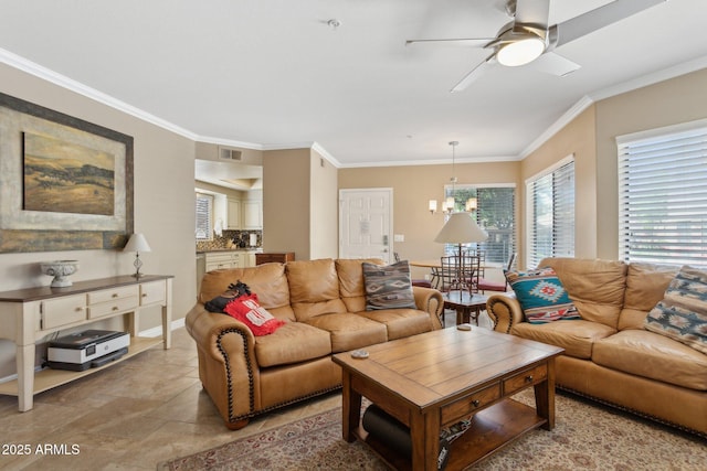 living area with a ceiling fan, crown molding, and light stone finish flooring