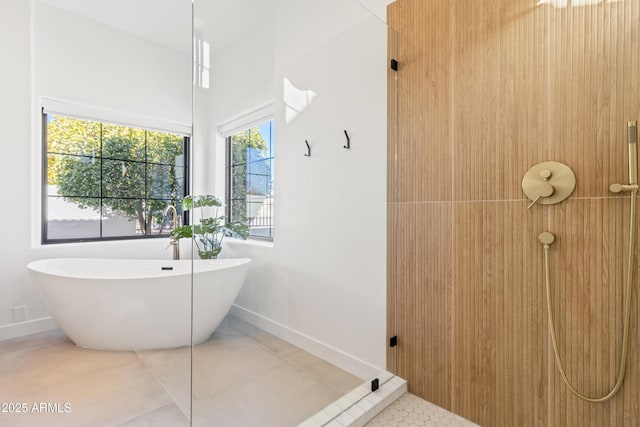 bathroom with a bath and tile patterned floors