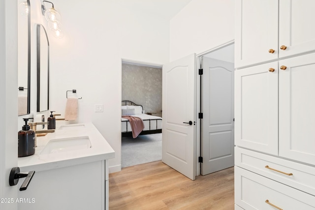 bathroom featuring vanity, a shower, and hardwood / wood-style floors