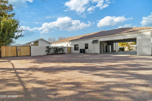 rear view of property featuring central AC unit