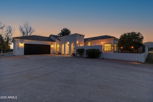 mediterranean / spanish-style house featuring a garage