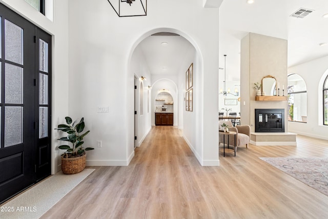 entryway featuring a large fireplace and light wood-type flooring