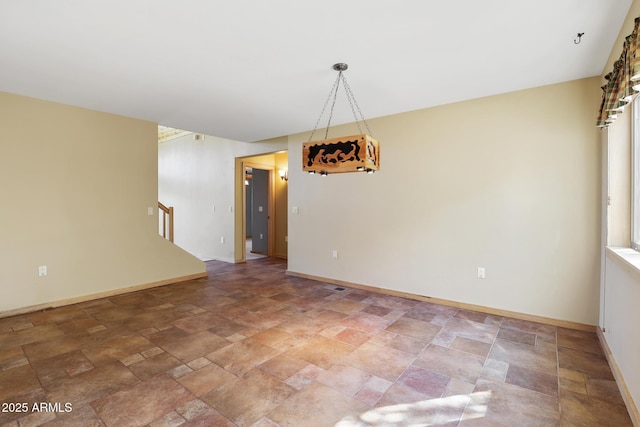 6602 W Dogwood Ln, Pine, AZ 85544 - unfurnished room featuring baseboards, stairs, and stone finish flooring