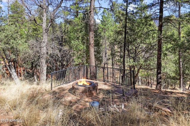 6602 W Dogwood Ln, Pine, AZ 85544 - view of yard with a wooded view and a fire pit