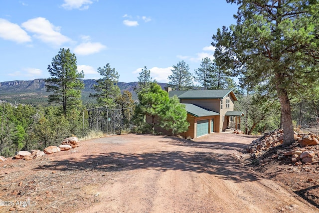 6602 W Dogwood Ln, Pine, AZ 85544 - exterior space featuring driveway, a chimney, and a garage