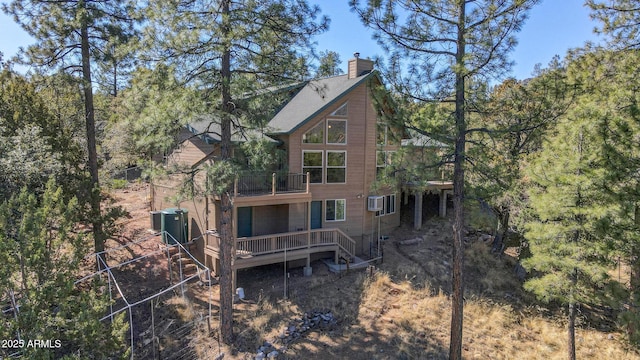 6602 W Dogwood Ln, Pine, AZ 85544 - rear view of property with a balcony, a chimney, a wooden deck, and a wall unit AC