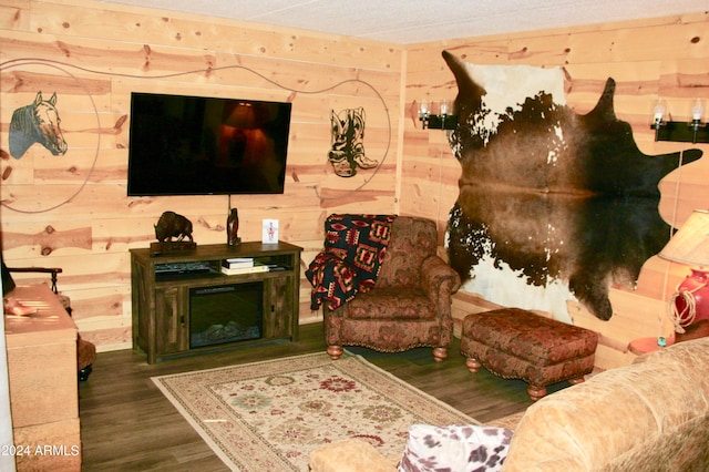 living room featuring wood walls and dark hardwood / wood-style flooring