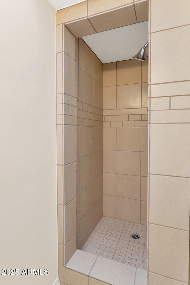 bathroom with a tile shower