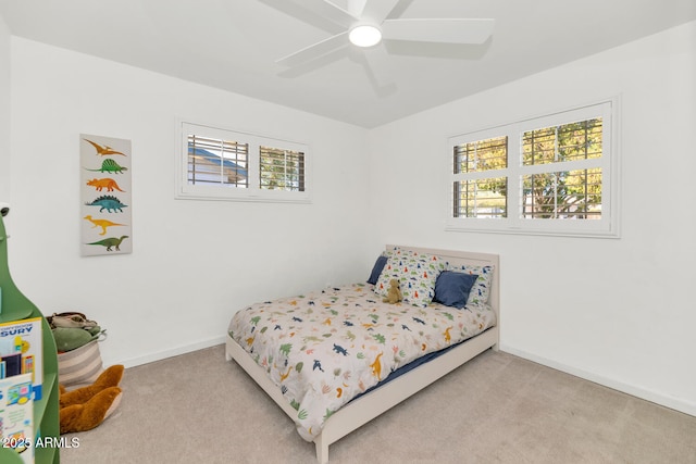 bedroom with ceiling fan and light colored carpet