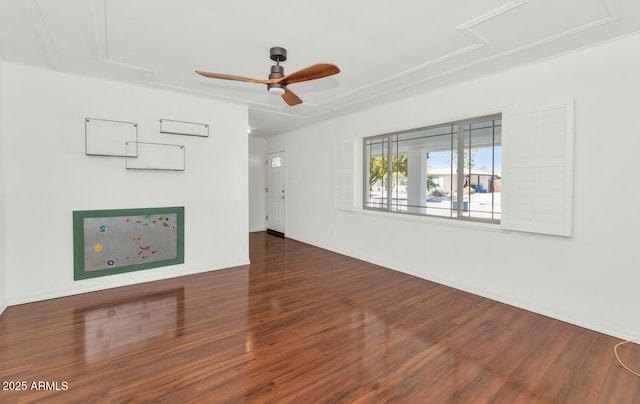 unfurnished living room featuring ceiling fan and dark hardwood / wood-style flooring