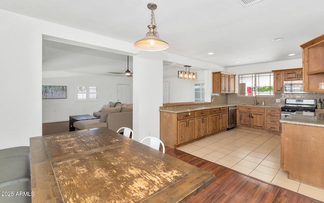 kitchen featuring pendant lighting, stainless steel appliances, sink, ceiling fan, and light tile patterned floors