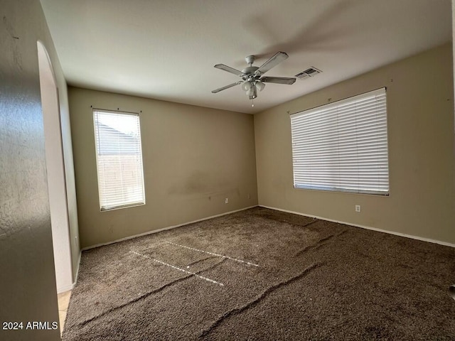 3030 S 102nd Ln, Tolleson, AZ 85353 - carpeted empty room with ceiling fan and arched walkways