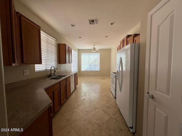 3030 S 102nd Ln, Tolleson, AZ 85353 - kitchen featuring white appliances, backsplash, recessed lighting, brown cabinetry, and light tile patterned floors