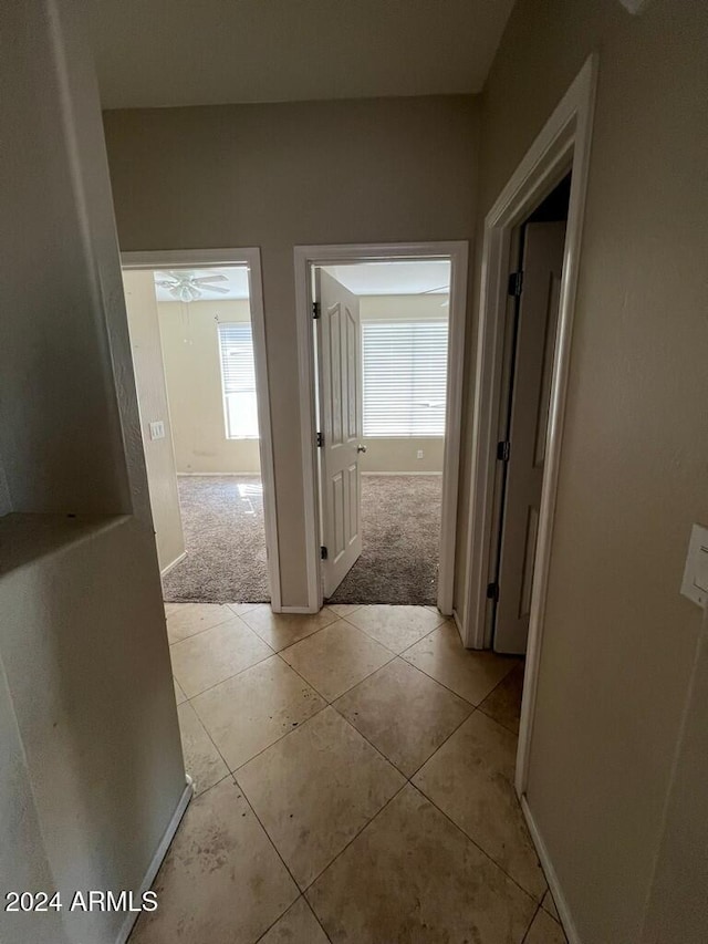 3030 S 102nd Ln, Tolleson, AZ 85353 - hall featuring light tile patterned flooring and light colored carpet