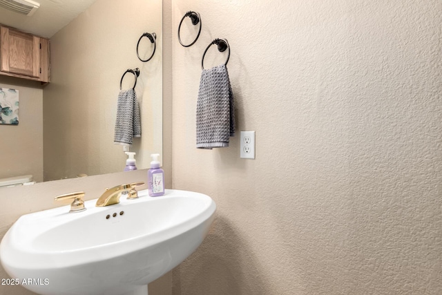 bathroom featuring toilet and sink