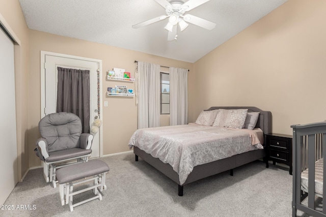 bedroom featuring lofted ceiling, carpet flooring, ceiling fan, and a closet