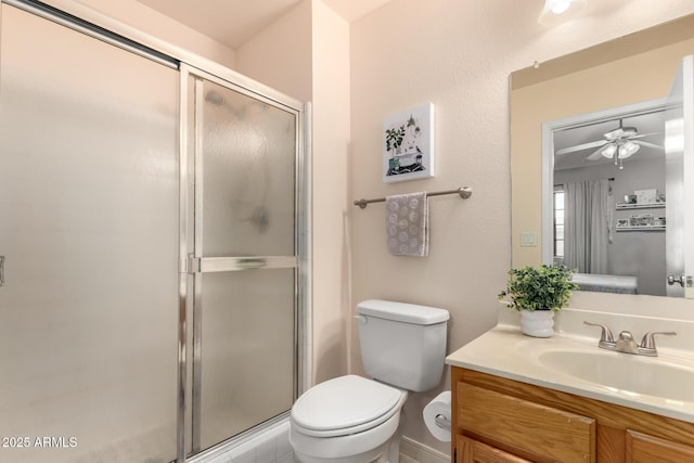 bathroom with vanity, a shower with shower door, and toilet