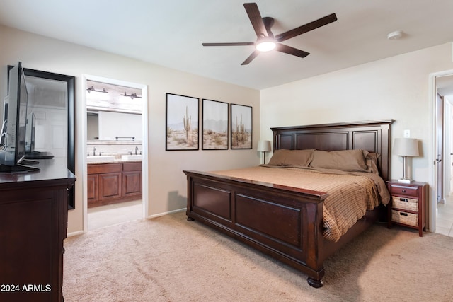 carpeted bedroom with ceiling fan, sink, and ensuite bathroom