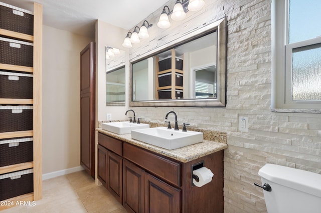 bathroom with tile patterned flooring, vanity, decorative backsplash, and toilet